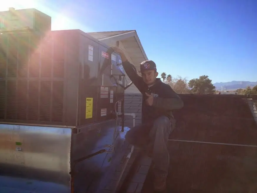 HVAC technician performing Boiler Repair on a rooftop unit in Parkwood